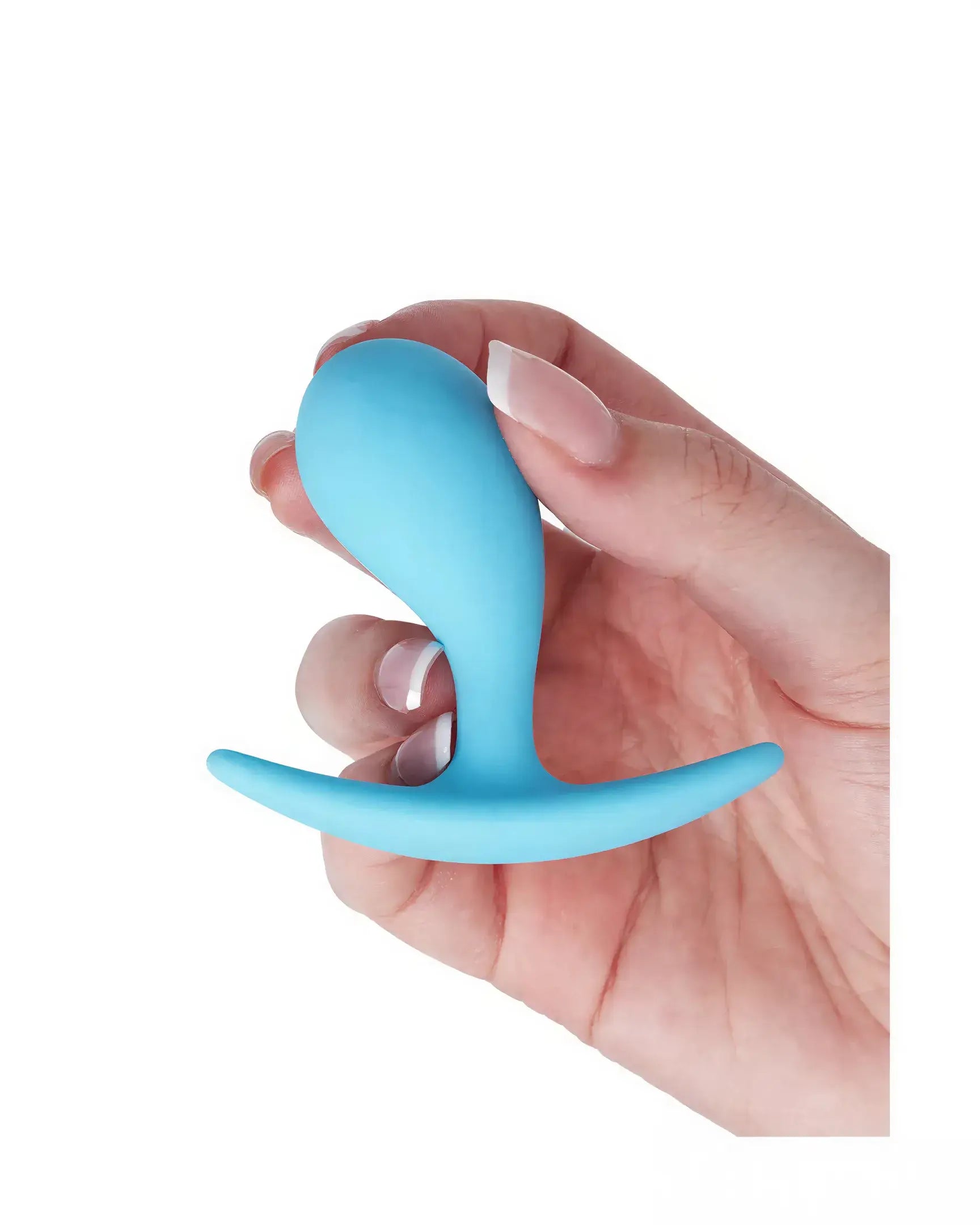 Medium curved plug in blue silicone held in a hand, featuring a tapered design and flared base for safety.