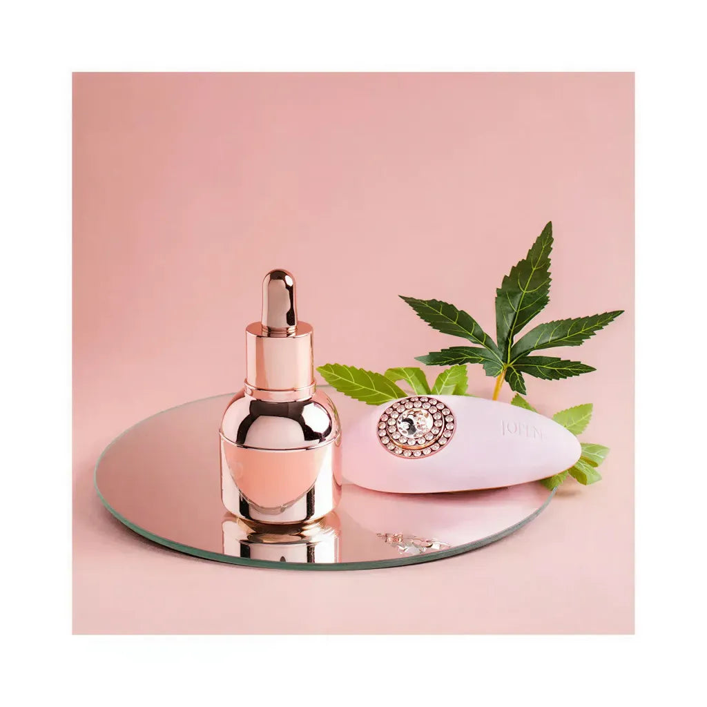 High On Love Pave Grace gift set featuring a rose gold dropper bottle and a white massager on a mirrored surface.