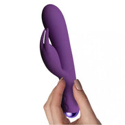 Rocks Off Flutter Rabbit 7-inch vibrator in purple, held by a hand, featuring a curved design and dual stimulation arms.