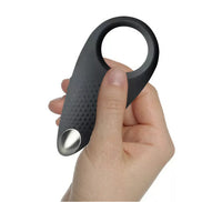 Rocks Off Men-X Empowerer vibrating cock ring held in a hand, featuring a textured surface and a metallic button.