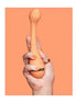 Vush Abbie G-Spot vibrator held in a hand, featuring a smooth orange design and ergonomic shape.