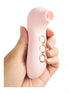 Hand holding a pink Share Satisfaction Coco device with three control buttons visible on the side.