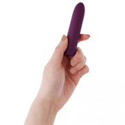 Berry Bullet vibrator held in a hand, featuring a sleek, purple design with a tapered tip.