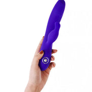 Azure rabbit vibrator held in a hand, featuring a smooth purple design and a prominent control button.