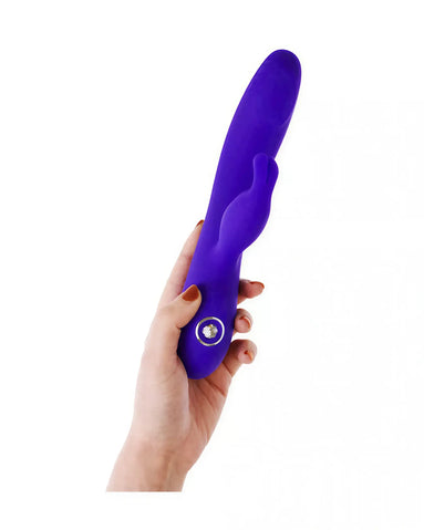 Azure rabbit vibrator held in a hand, featuring a smooth purple design and a prominent control button.