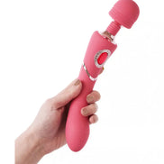 Sana luxury wand in pink, held by a hand, featuring a rounded head and a decorative control button.