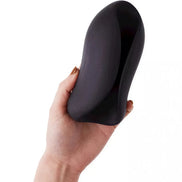 Jeron vibrating stroker held in a hand, featuring a sleek black design with a smooth, curved shape.