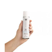 Share Satisfaction water-based lubricant in a clear bottle held in a hand, featuring a white cap and label.