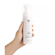 Share Satisfaction foaming toy cleaner in a white bottle, held in a hand, with a pump dispenser and green label.