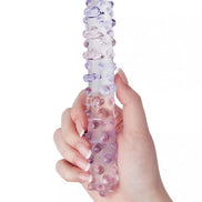 Lucent velour beaded glass massager held in a hand, featuring a clear body with purple and lavender beads.