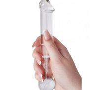 Lucent Mars glass dildo held in a hand, featuring a clear design with rounded ends and smooth surface.