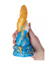 Kinki Cthulhu tentacle dildo in blue and orange, featuring textured details and a hand holding it for scale.