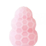 Reversible honey stroker in soft pink silicone with a honeycomb texture and rounded top.