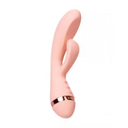 Vush Muse Rabbit Vibrator in soft pink with a gold band and dual stimulation design, angled view showcasing its shape.