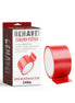 Behave Bind Me bondage tape in red, displayed on a roll next to its packaging featuring bold text and a decorative design.