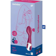 Satisfyer Hot Spot vibrator in a pink and white design, displayed in a colorful box with line art on the front.