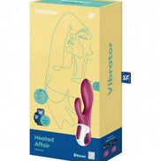 Satisfyer Heated Affair vibrator in a pink and white design, displayed in its colorful packaging with line art.