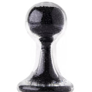 Lucent glass butt plug in black, featuring a rounded top and tapered base, with a transparent outer layer.