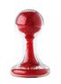 Lucent glass butt plug with a clear body and red glittery interior, featuring a rounded top and flared base.