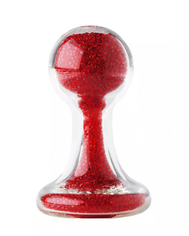 Lucent glass butt plug with a clear body and red glittery interior, featuring a rounded top and flared base.