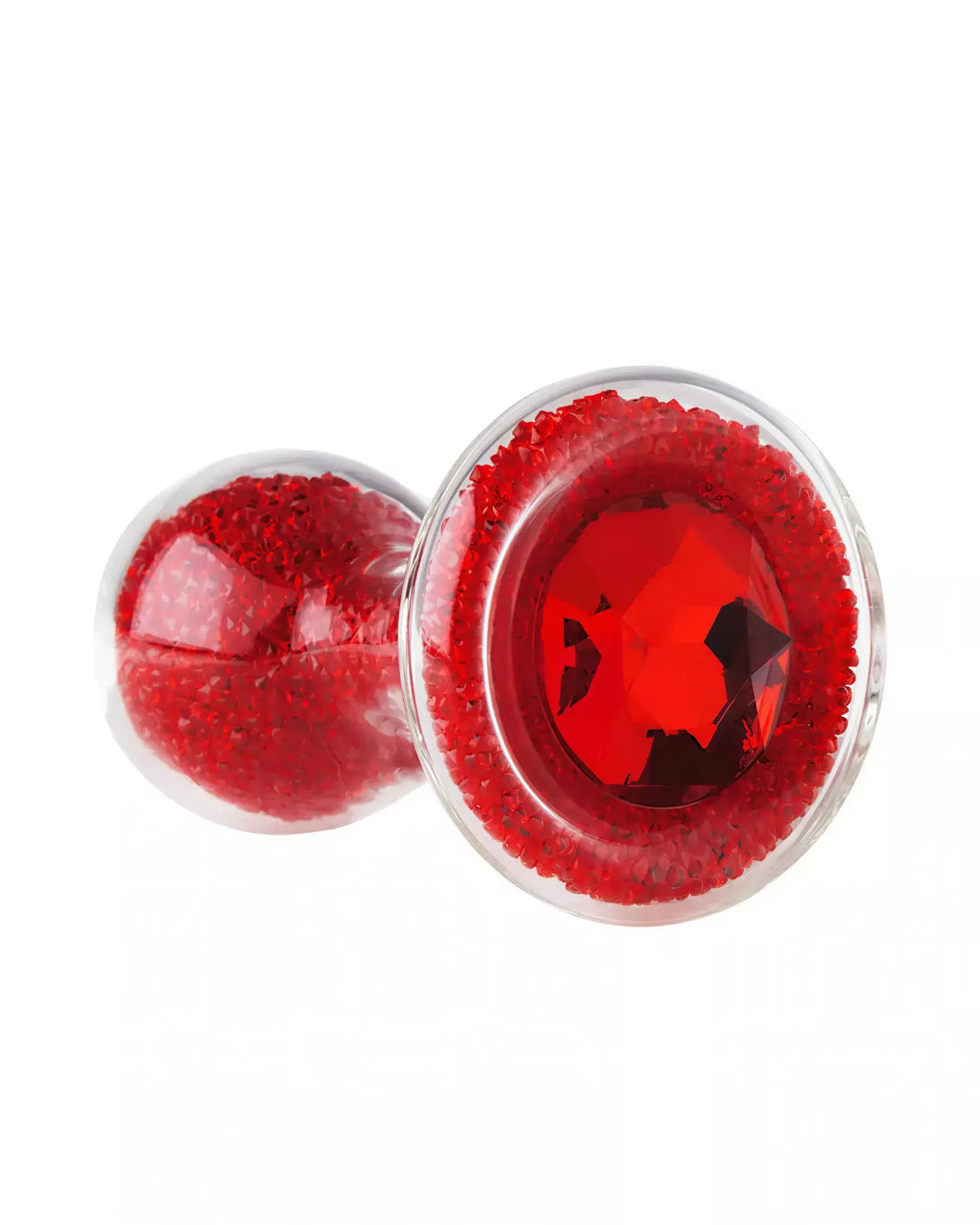 Lucent glass butt plug in red with a gem-like design and a transparent body, showcasing decorative red glitter.