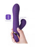 Purple thrusting suction vibrator held in a hand, featuring ridges and a curved design for targeted stimulation.