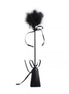 Black feather tickler with a long handle and satin ribbons tied at the base.