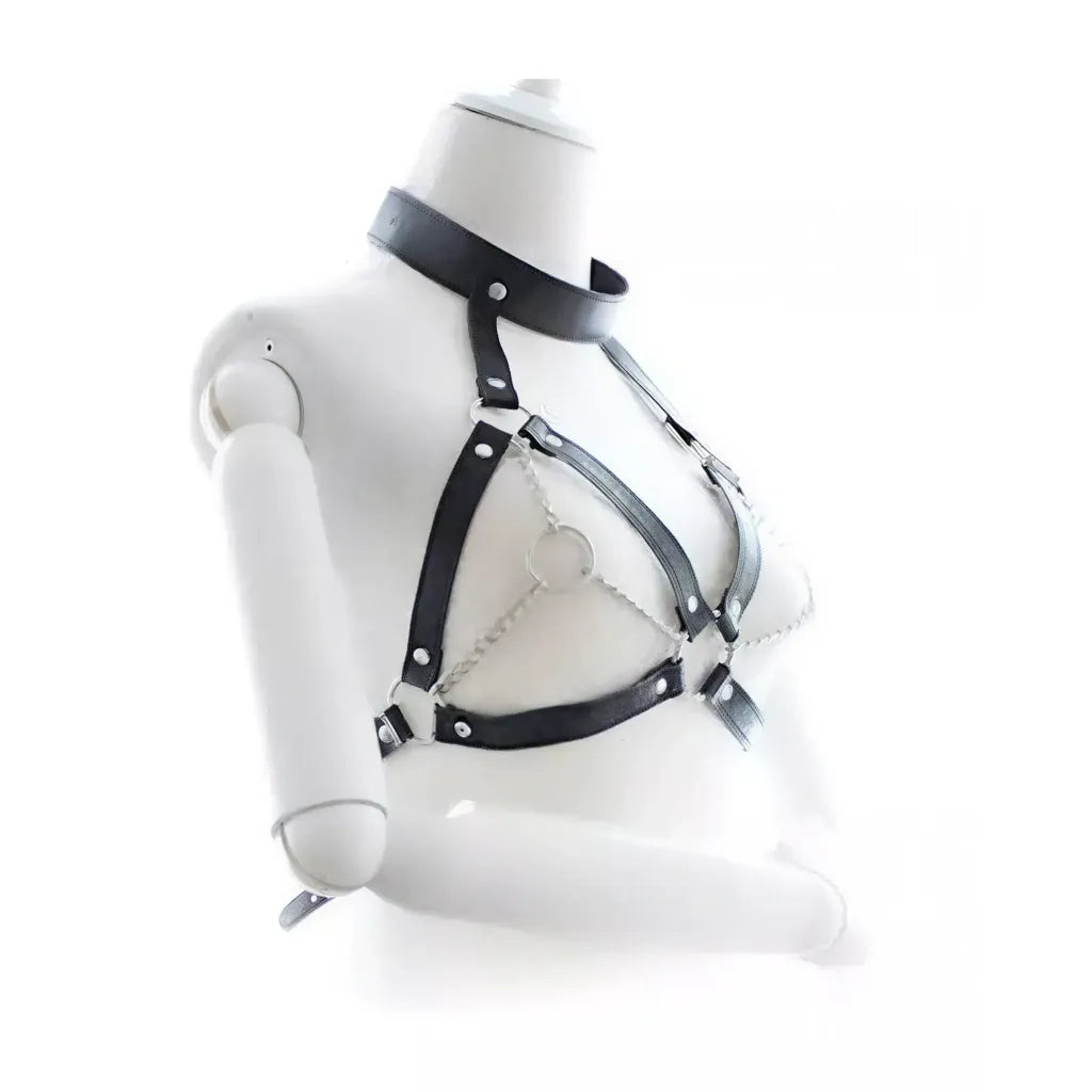 Black leather harness on a mannequin bust against a white background