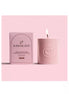 High On Love massage candle in a textured pink container with a matching box, featuring a logo and a lit wick.