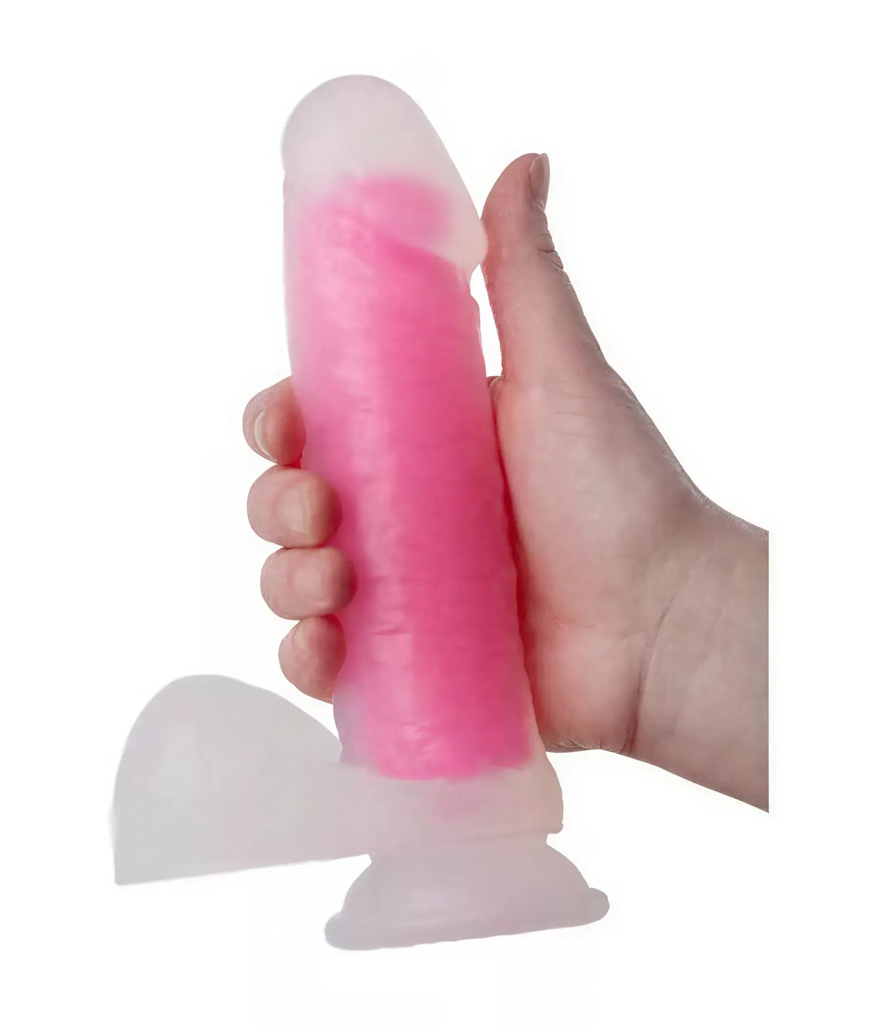 Nood Colours glow in the dark dildo, 8.1 inches long, held in a hand, featuring a pink translucent design.