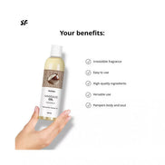 Satisfyer coconut massage oil bottle held in hand, featuring a white label with benefits listed and a light background.