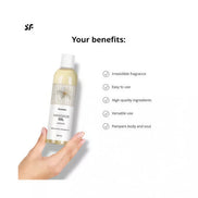 Satisfyer jasmine massage oil bottle held in hand, featuring a light yellow liquid and white label with benefits listed.