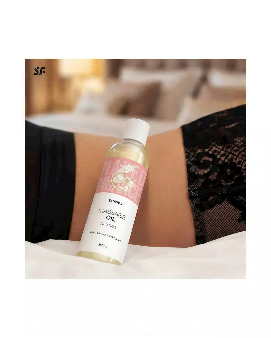 Satisfyer Massage Oil Neutral 250ml bottle on a bed with lace fabric in the background.