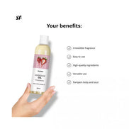 Satisfyer massage oil in a 250ml bottle with strawberry fragrance, held in a hand against a white background.