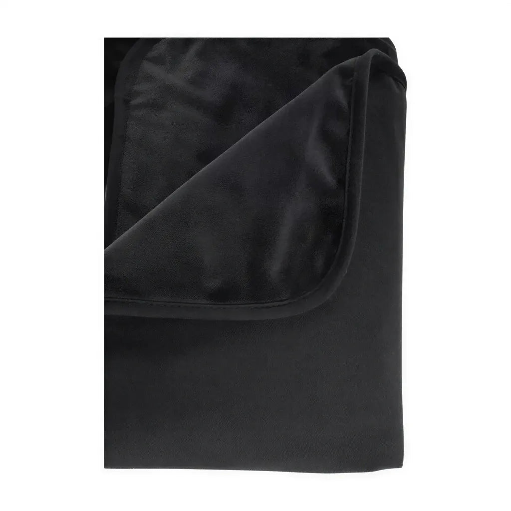 Pivot Protector waterproof blanket in black, showcasing a folded corner with soft, plush texture.