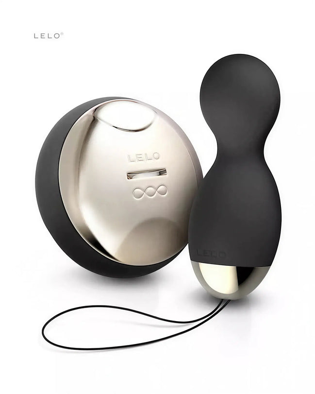 Lelo Hula Beads in black silicone with a shiny gold base and a charging case, displayed on a white background.