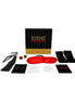 Bondage Seductions game set featuring a black and red box, dice, cards, a blindfold, and a whip.