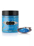 Kama Sutra Treasures of the Sea bath salts in a blue container with seashell design, alongside a shell filled with salts.