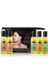 Kama Sutra Massage Tranquility Kit with eight massage oils in clear bottles, displayed with a black pouch and a model in t...