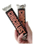Two Chocolust bars held in a hand, featuring a black wrapper with bold pink text.